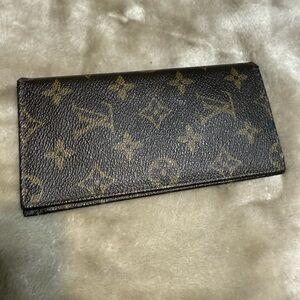 Louis Vuitton Dark Brown Monogram checkbook cover. Vintage and worn.